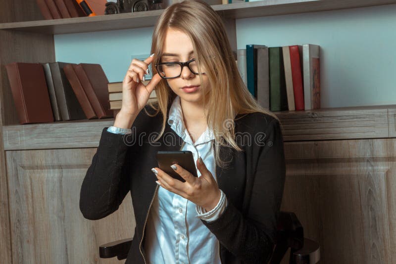 Business lady in glasses working on phone