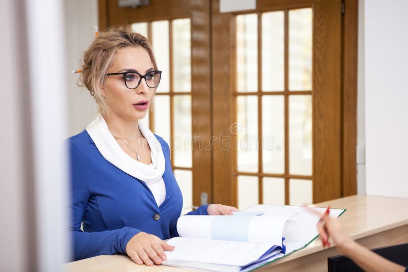 Business Lady with Her Blonde Secretary in the Waiting Area of a Stock