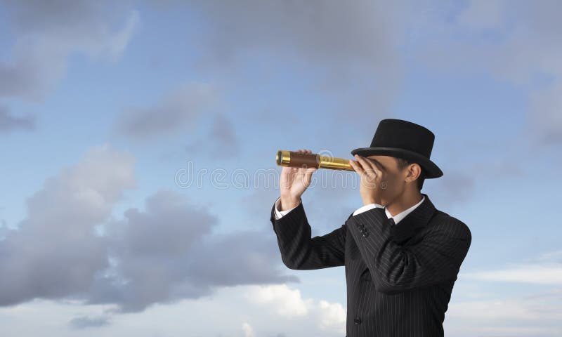 Businessman is looking trough telescope. Businessman is looking trough telescope