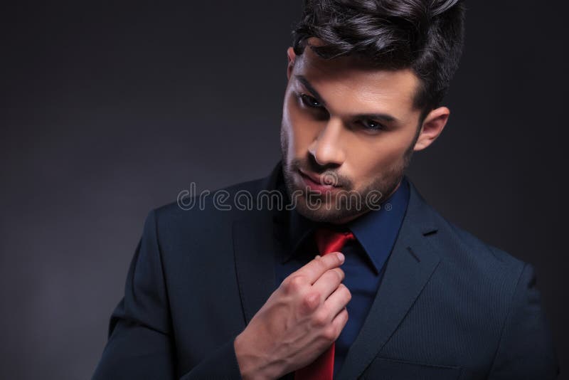 Business man adjusts his tie stock photography