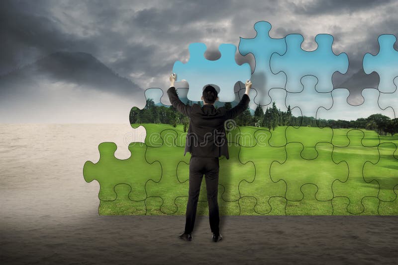 Business Man Assemble Puzzle To Change From Desert To Landscape