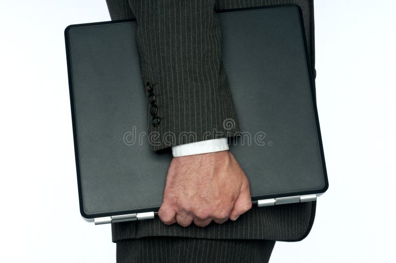 A business man carrying a computer