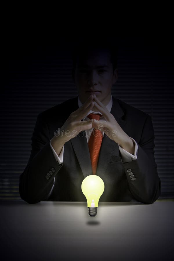 Business man with glowing light bulb stock photo Business man with glowing light bulb stock photo