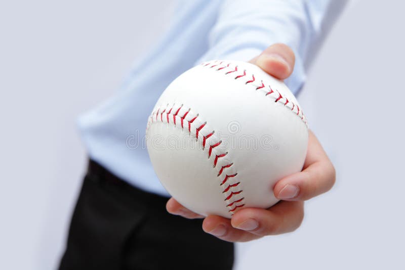 Business man hand holding a baseball in the office