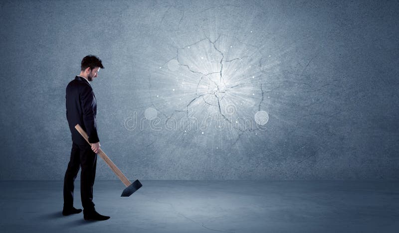 Business man hitting wall with a hammer