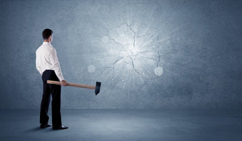 Business man hitting wall with a hammer