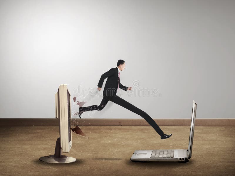 Business man with long leg out from computer desktop to laptop