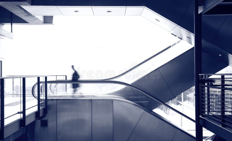 Business man move on escalator