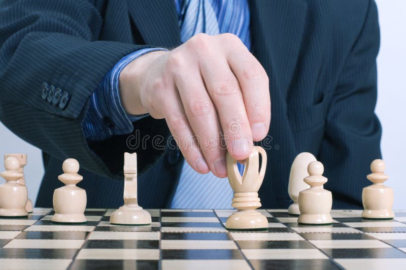 Business man moving chess figure royalty free stock photo