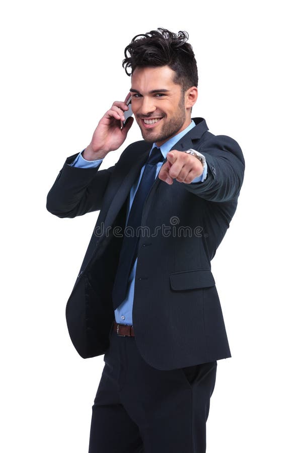 Business man pointing finger while talking on smartphone