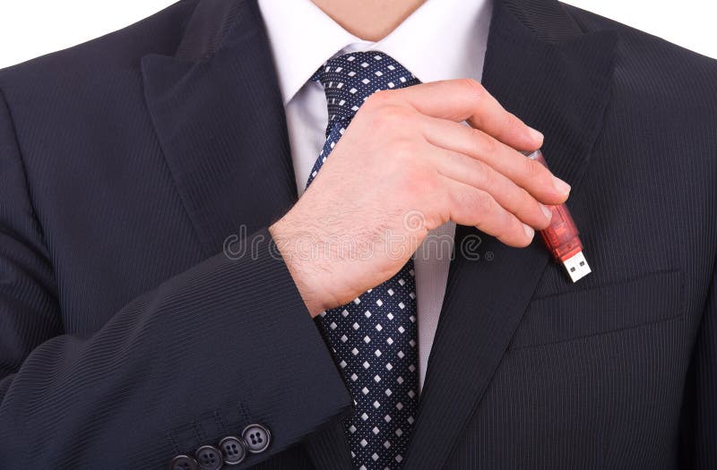 Businessman putting usb stick in his pocket. stock photo