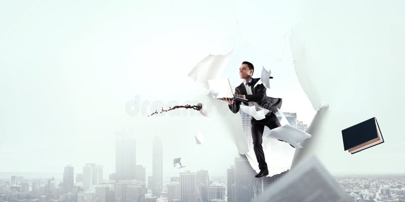 The business man is running with his notebook through paper hole stock photo