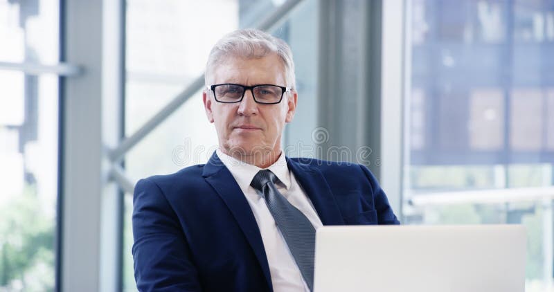 Business man, senior portrait and laptop on office desk of an executive with focus on career. Face of a professional and