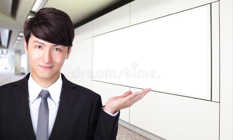 Business man shows you empty billboard