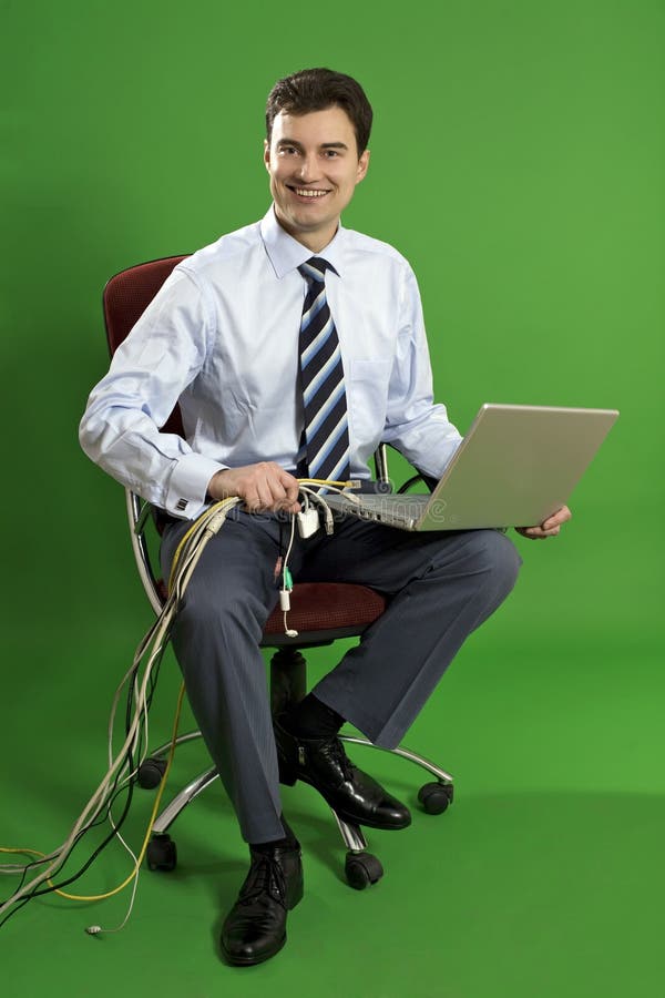 Business man sitting in the chair with laptop on h stock photo