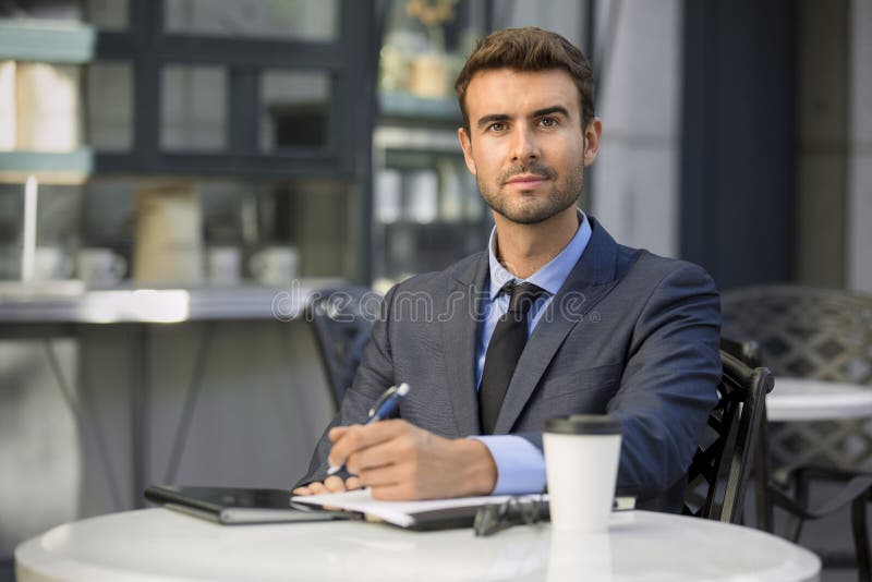 Business man sitting at coffee shop with paperwork portrait stock photography Business man sitting at coffee shop with paperwork portrait stock photography