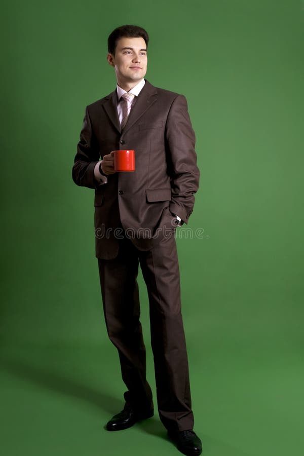 Business man standing with a cup royalty free stock image