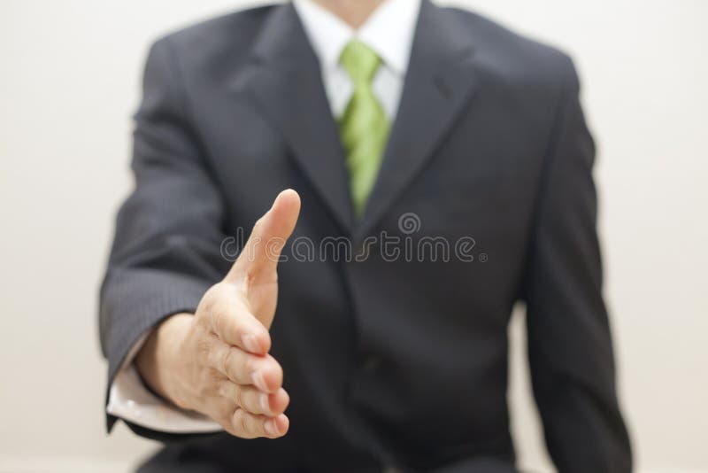 Business man in suit offers to shake hands