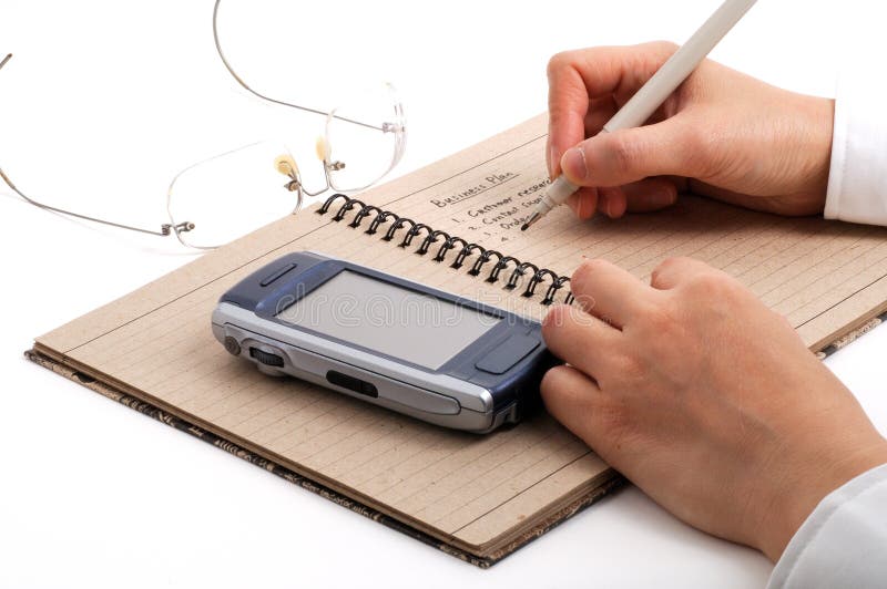 Business man taking meeting notes with cell phones and glasses royalty free stock photos Business man taking meeting notes with cell phones and glasses royalty free stock photos