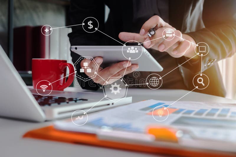 Business man using digital tablet analyzes business data, busy working on laptop computer and business report on office desk. royalty free stock photography