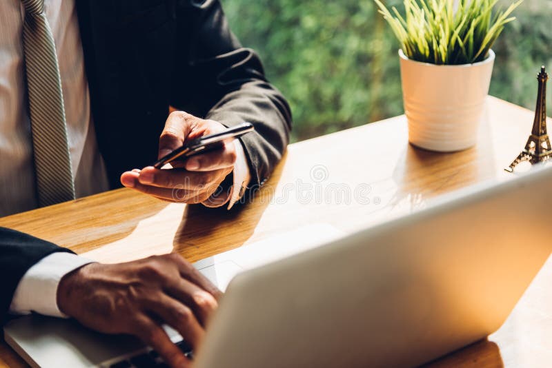 Business man using technology mobile smart phone with laptop com stock photo Business man using technology mobile smart phone with laptop com stock photo