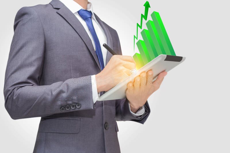 Business man using touchpad, tablet to retrieve and analyze data with green stick graph indicator on the top of tablet PC. stock images