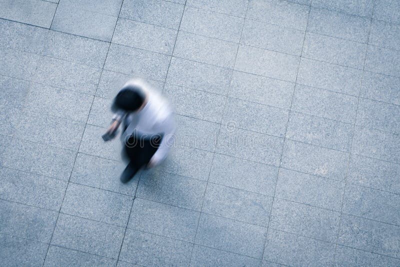 Blur business man walking and using smart phone on the street