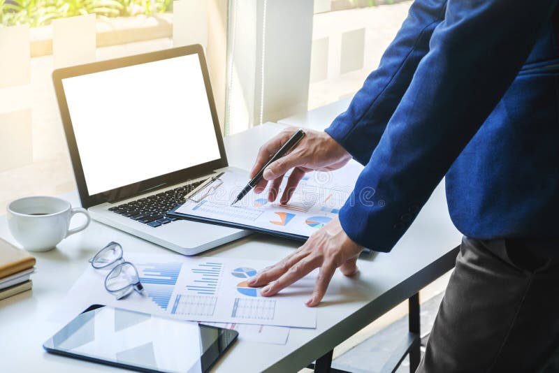 Business man working analysis data documents of stock market company at the office with blank screen laptop stock photography