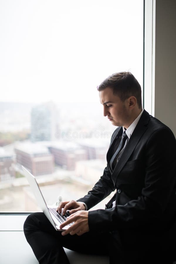business man working near panoramic city window on laptop royalty free stock photo business man working near panoramic city window on laptop royalty free stock photo