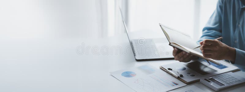 Business man writing a message on an empty notebook, taking memos in a notebook, taking important messages, writing a daily diary stock photography