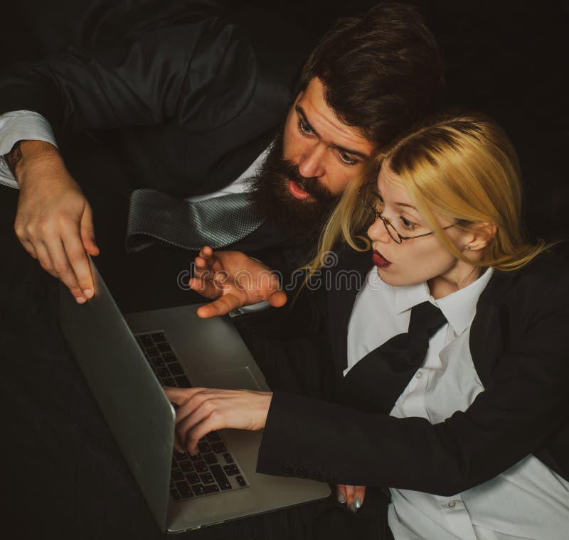 Business management. Young business people talking on black background. Hackers using laptops. royalty free stock photo