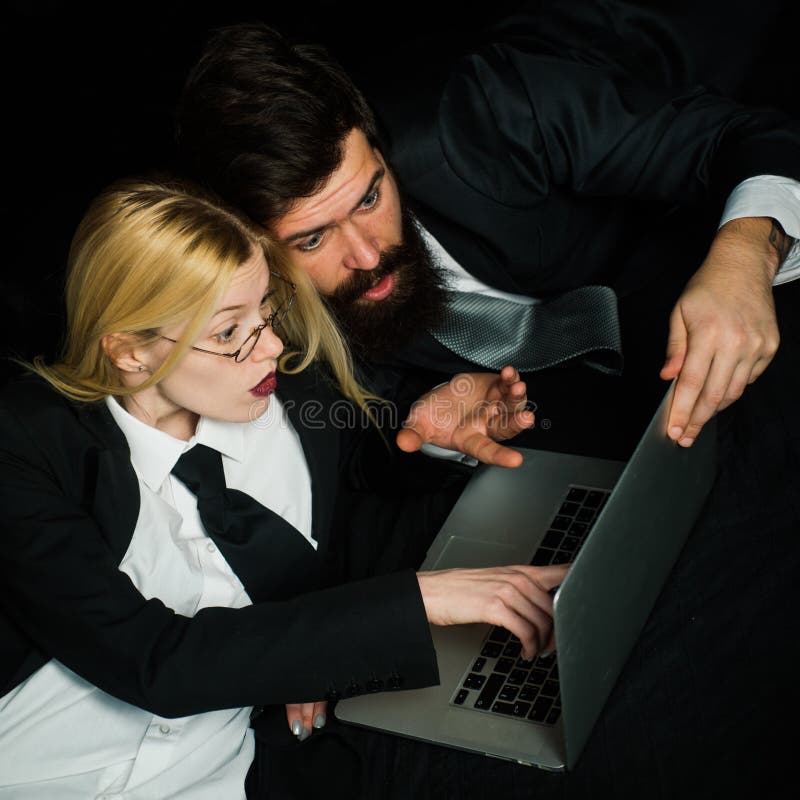 Business management. Young business people talking on black background. Hackers using laptops. stock photos