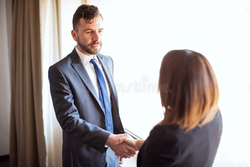 Business manager giving handshake to a client stock photography Business manager giving handshake to a client stock photography