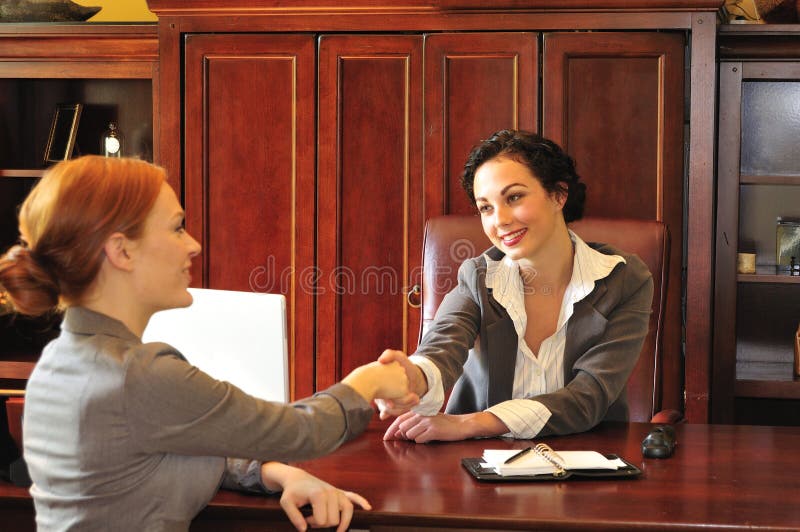 Due donne, saluto a vicenda in un ufficio riunione.