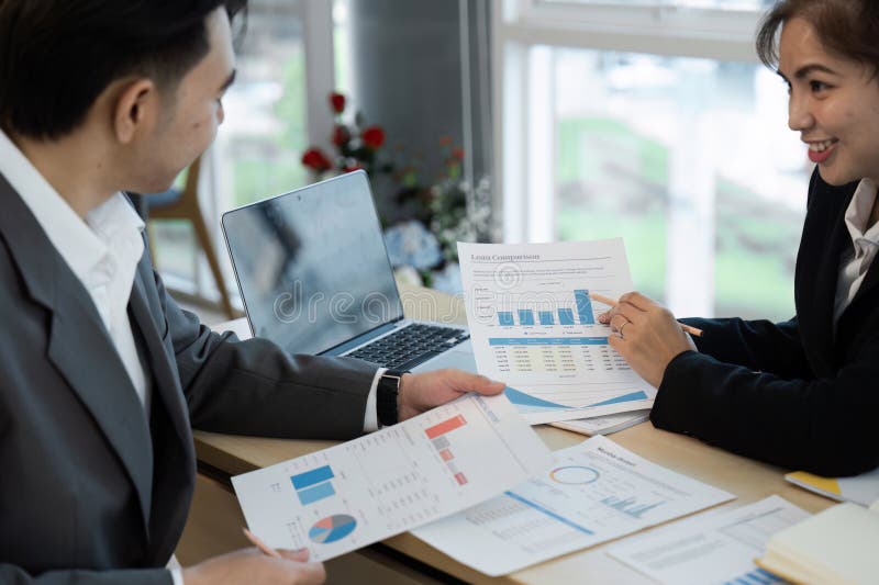 Business Meeting with Colleagues Analyzing Financial Reports and Graphs in a Modern Office Setting royalty free stock images