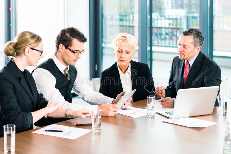 Business - meeting in office, the businesspeople or lawyers in team are discussing a document on Laptop computer. Business - meeting in office, the businesspeople or lawyers in team are discussing a document on Laptop computer