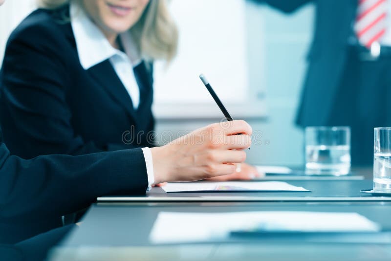 Business - meeting in an office, lawyers or attorneys discussing a document or contract agreement. Business - meeting in an office, lawyers or attorneys discussing a document or contract agreement