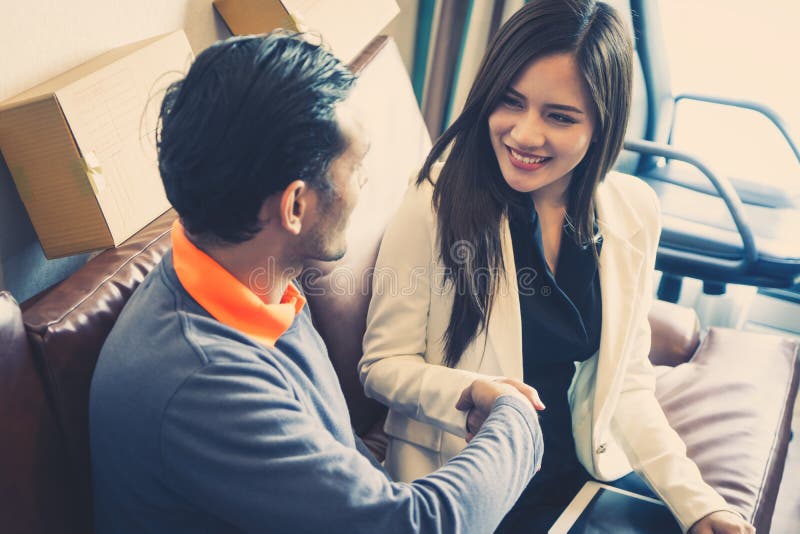 Business man gladly smile shaking hand with female partner