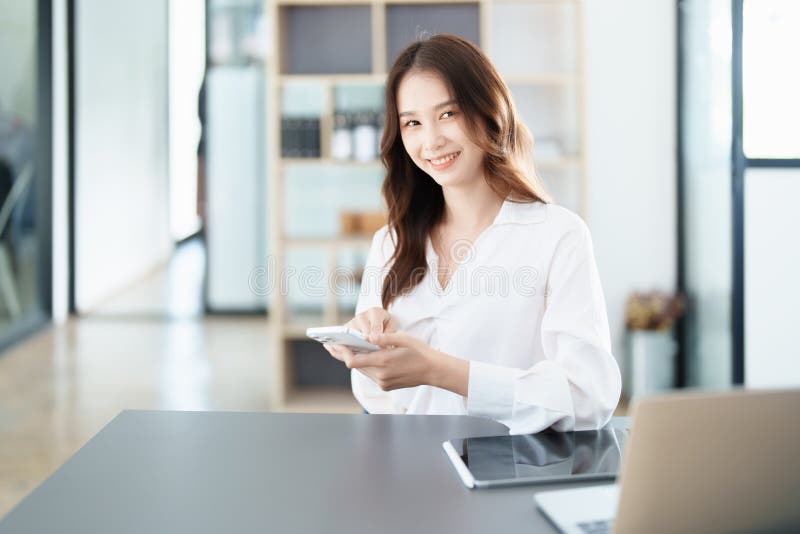 Business owner or Asian male marketers are using business phones in office work royalty free stock photography