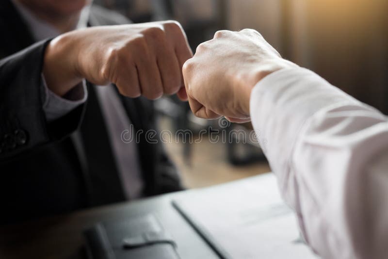 Business Partners Giving Fist Bump to commitment Greeting Start up new project or complete mission successful deal together with strong teamwork. startup concept