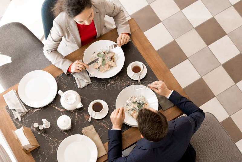Business partners having dinner together in restaurant royalty free stock photo Business partners having dinner together in restaurant royalty free stock photo