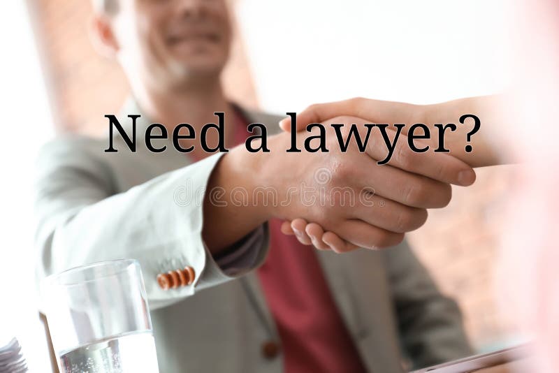 Business partners shaking hands at table in office. Need a lawyer stock images Business partners shaking hands at table in office. Need a lawyer stock images