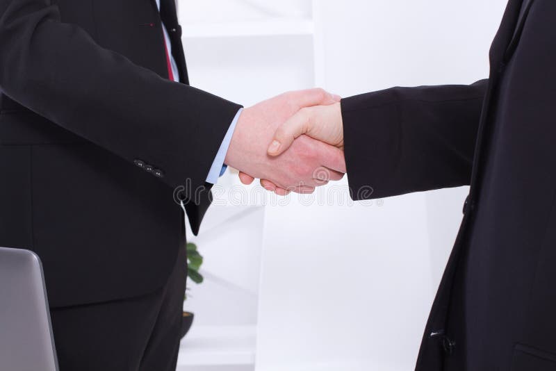 Stylish Successful businessmen handshaking after profitable deal at office background. Image of businessmans handshake in suits royalty free stock photography Stylish Successful businessmen handshaking after profitable deal at office background. Image of businessmans handshake in suits royalty free stock photography