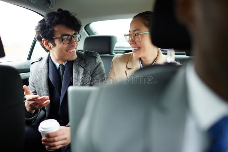 Business people Chatting in Backseat of Car stock image Business people Chatting in Backseat of Car stock image