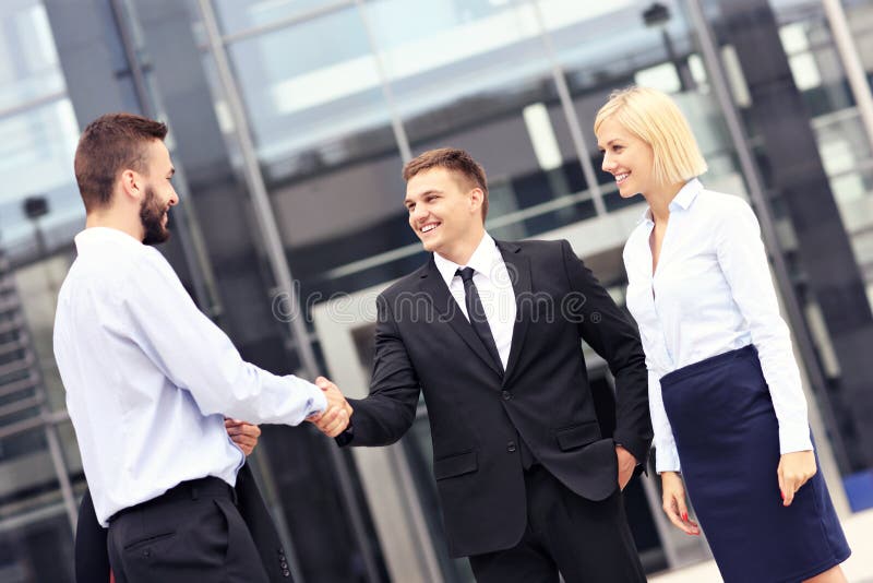 Business people greeting outside modern building royalty free stock photos