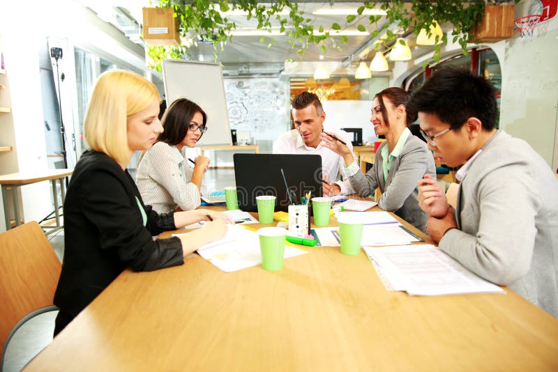 Business people having meeting around table stock photo Business people having meeting around table stock photo