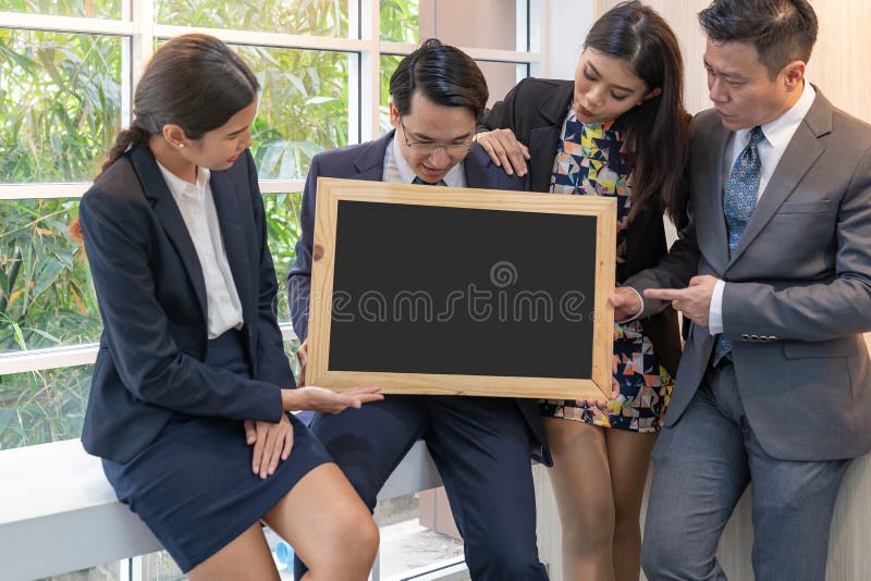 Business people hold blank blackboard royalty free stock image