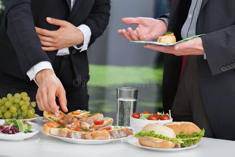 Business people discussing at the lunch buffet. Business people discussing at the lunch buffet