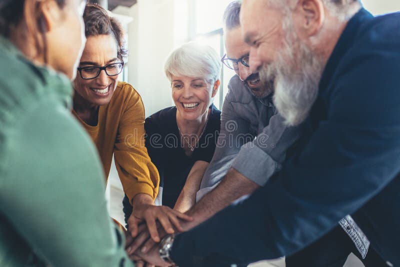 Business people making pile of hands stock image Business people making pile of hands stock image