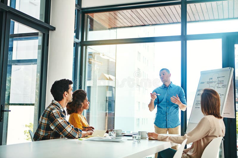 Business people, man and presentation in conference room with discussion for company growth and common goals. Speaker royalty free stock image